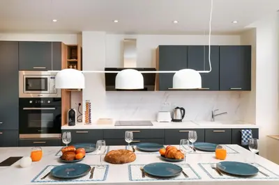 a kitchen with a table with plates of food on it at L'art de Gambetta ConciergerieDameCarcas in Carcassonne