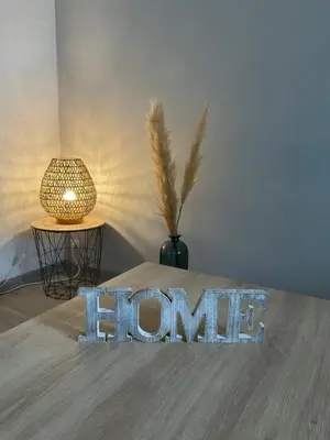 a home sign on a table with a lamp at NATURE by Reine du Sud, proche des Grands Buffets in Narbonne