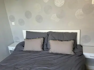 a bed with two pillows on it in a bedroom at NATURE by Reine du Sud, proche des Grands Buffets in Narbonne