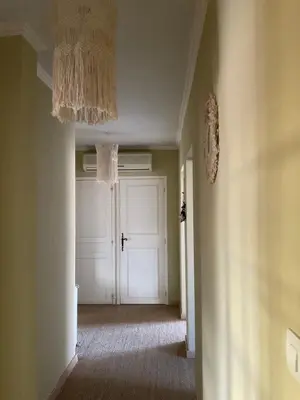 an empty hallway with a white door in a room at NATURE by Reine du Sud, proche des Grands Buffets in Narbonne