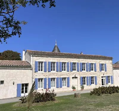 a large white building with blue shutters at Domaine de Lanis - Chambres d'hôtes avec parc et piscine in Castelnaudary