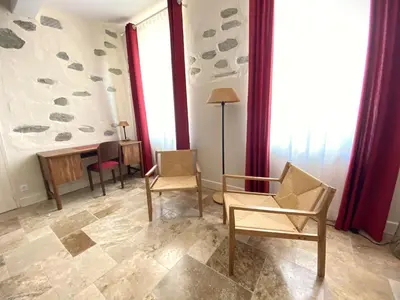 a living room with chairs and a table and windows at Domaine de Lanis - Chambres d'hôtes avec parc et piscine in Castelnaudary