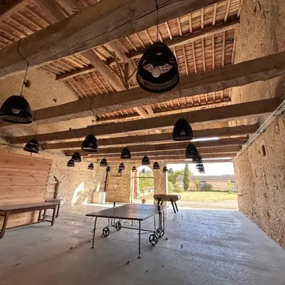 a room with two ping pong tables in it at Domaine de Lanis - Chambres d'hôtes avec parc et piscine in Castelnaudary