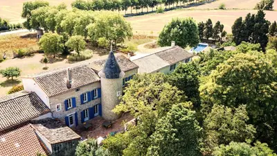 an aerial view of a house with a turret at Domaine de Lanis - Chambres d'hôtes avec parc et piscine in Castelnaudary
