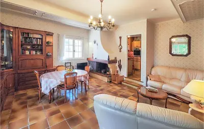 a living room with a table and a couch at 2 Bedroom Cozy Home In Cébazan in Cébazan