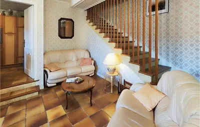 a living room with two couches and a staircase at 2 Bedroom Cozy Home In Cébazan in Cébazan