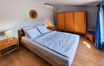 a bedroom with a bed and a dresser and a bed sidx sidx sidx sidx at 2 Bedroom Cozy Home In Cébazan in Cébazan