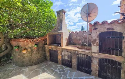an old building with a gate and a basketball hoop at 2 Bedroom Cozy Home In Cébazan in Cébazan