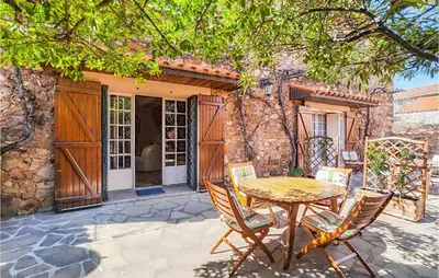 a patio with a table and chairs in front of a building at 2 Bedroom Cozy Home In Cébazan in Cébazan