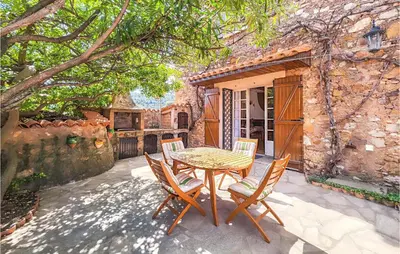 a patio with a table and chairs in front of a building at 2 Bedroom Cozy Home In Cébazan in Cébazan