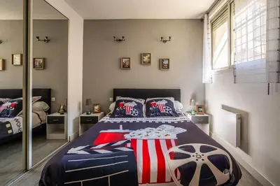 a bedroom with a bed with a soccer ball on it at L'appart cinéma Centre ville Narbonne in Narbonne