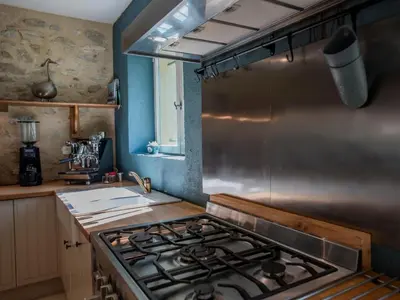 a kitchen with a stove top oven in a kitchen at Lécurie in Montréal