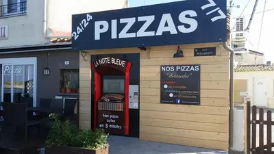 a pizza shop with a red door and a sign at Les mobil homes de NOLY TV CLIM 6places in Port-la-Nouvelle