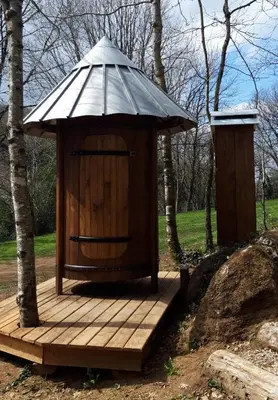 a wooden out house with a roof on a wooden deck at Le tipi à Marie, déconnectez- vous !!! in Cambounès