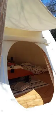 a room with two beds in a tent at Le tipi à Marie, déconnectez- vous !!! in Cambounès