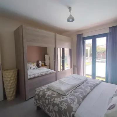 a bedroom with a bed and a large window at Villa Félines in Félines-Minervois
