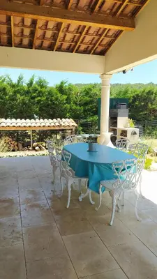 a blue table and chairs on a patio at Villa Félines in Félines-Minervois