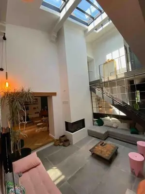 a large living room with a couch and a fireplace at Maison de famille (piscine, jacuzzi et sauna) in Quillan