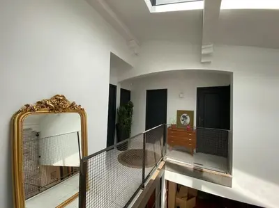 a hallway with a mirror and a mirror at Maison de famille (piscine, jacuzzi et sauna) in Quillan
