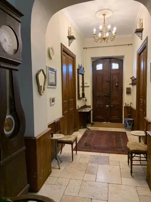 a hallway with a clock on the wall at La Maison du Magistrat in Durban-Corbières