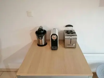 a table with a coffee maker and a blender on it at Le soleil d Eugènie appartement dans résidence avec Piscine commune près de Carcassonne in Olonzac
