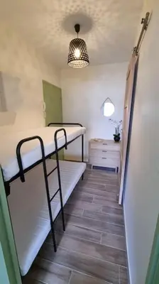 a small room with two bunk beds in it at Magnifique Studio sur le Port de Gruissan (2 à 4 pers) in Gruissan