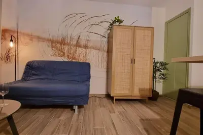 a bedroom with a bed and a cabinet and a table at Magnifique Studio sur le Port de Gruissan (2 à 4 pers) in Gruissan