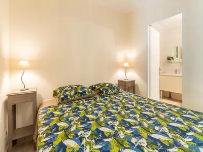 a bedroom with a bed with a blue and yellow bedspread at Charming Villa Stay Near Limoux in Limoux