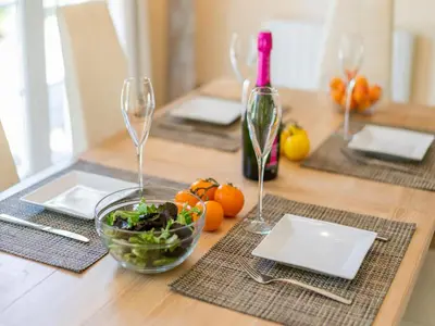 a table with two wine glasses and a bowl of salad at Charming Villa Stay Near Limoux in Limoux