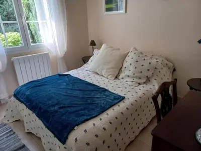 a bedroom with a bed with a blue blanket on it at Charming Villa Stay Near Limoux in Limoux