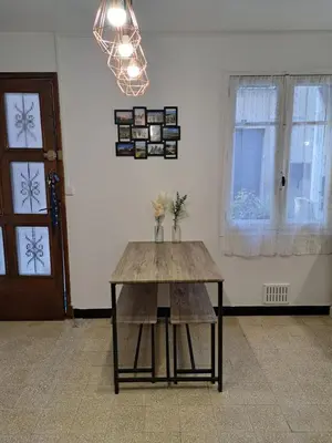 a wooden table in a room with a window at Bel appartement 2/4personnes in Douzens