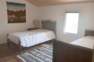 a bedroom with two beds and a window at Gîte de l'arbre perché à Langel in Armissan