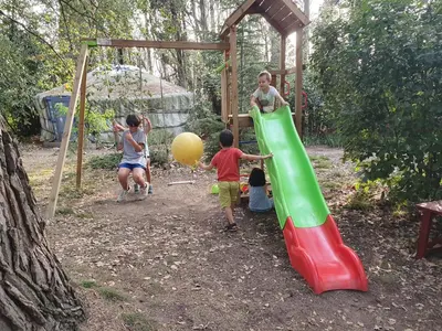 a group of children playing on a slide at a playground at Gîte de l'arbre perché à Langel in Armissan