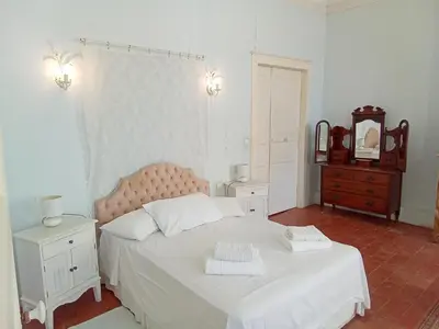 a bedroom with a bed and a table and chairs at OCC34 - Capestang - Manoir in Capestang