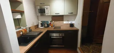 a small kitchen with a sink and a microwave at Gîte du parc à Langel in Armissan