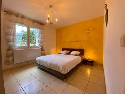 a bedroom with a bed and a window at Gîte Romarin avec SPA in Saint-Jean-de-Barrou
