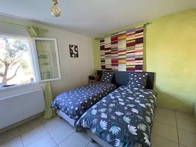 a bedroom with a bed and a window at Gîte Romarin avec SPA in Saint-Jean-de-Barrou