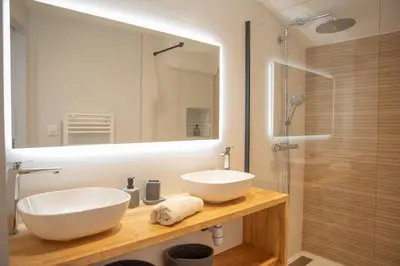 a bathroom with a white sink and a mirror at La maison rue Nadaud, au pied des remparts in Carcassonne