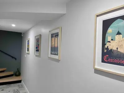 a group of pictures on a wall in a room at La maison rue Nadaud, au pied des remparts in Carcassonne