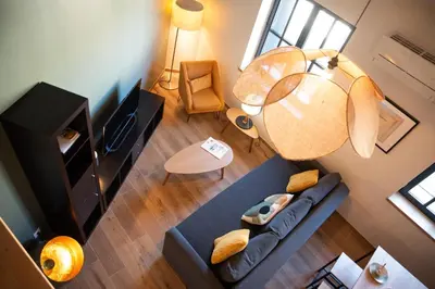 an overhead view of a living room with a blue couch at La maison rue Nadaud, au pied des remparts in Carcassonne