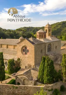 an old stone building with a tower and a church at Studio mosaïque Narbonne in Narbonne
