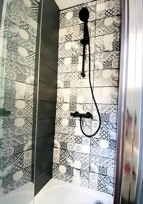 a shower in a bathroom with a tile wall at Studio mosaïque Narbonne in Narbonne