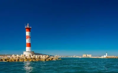a lighthouse on a rock island in the water at Les mobil homes de Naka, 6 places, TV, CLIM in Port-la-Nouvelle