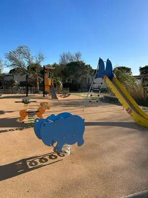 a playground with a blue bear and a slide at Les mobil homes de Naka, 6 places, TV, CLIM in Port-la-Nouvelle