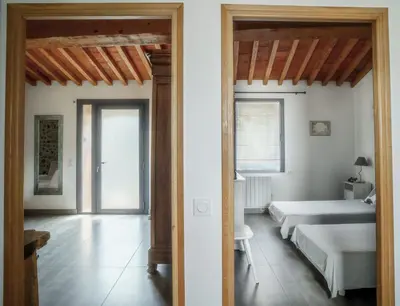 a bedroom with two beds and a room with two beds at Côté Grange à Bélesta in Bélesta