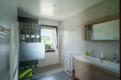 a bathroom with a sink and a mirror at Côté Grange à Bélesta in Bélesta