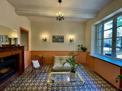 a living room with a couch and a fireplace at Maison vigneronne de Bonne Maman - climatisée in Cesseras