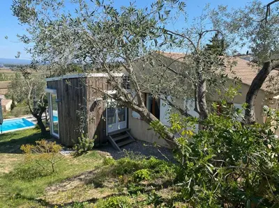 a tiny house with a pool in a yard at Neuve Romantique in Montbrun-des-Corbières