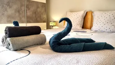 a bed with a blue stuffed swan on it at Villa d'Architecte - Cocon Design, Calme & Mer in Fitou