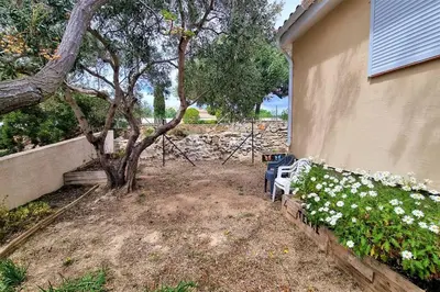 a yard with a tree and a house at Villa d'Architecte - Cocon Design, Calme & Mer in Fitou